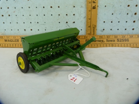 Unmarked metal John Deere toy seeder, 7" L