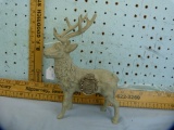 Cast iron stag doorstop with Winchester Repeating Arms watch fob glued to side, 9