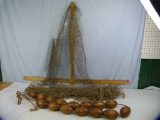 String of 15 wooden fishing net buoys & 2 fishing nets