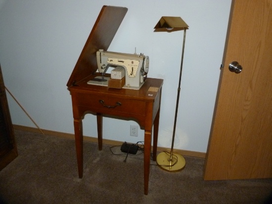 Singer Model 237 sewing machine in cabinet and curved neck floor lamp.
