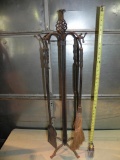 Early ornate cast iron fire place tool set.