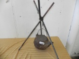 Antique cast iron kettle and stand labeled Home Stove Works.