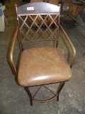 Brown metal swivel bar stool with leather seat.