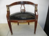 Ornate cherry wood claw foot chair with leather seat.