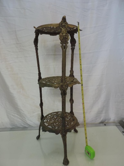 28x9x9" solid brass ornate plant stand in good condition.