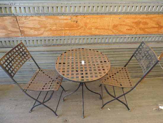 Round 24x26" metal patio table with 2 matching metal fold up chairs.