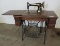 Antique singer sewing machine machine with 4 drawer cabinet.