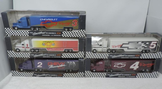 5 limited edition 1/64 scale racing transporter die cast trucks.