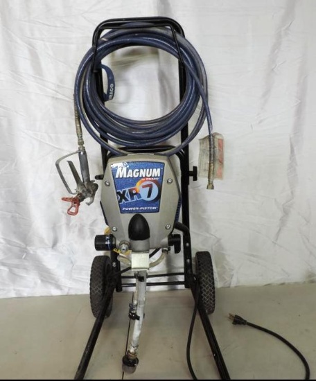Graco Magnum XR7 paint sprayer with hose and spray gun.