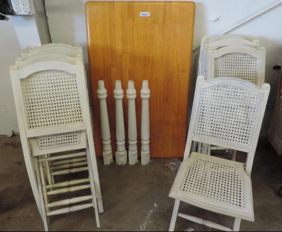 30x48" oak top table with 8 white wicker fold up chairs.
