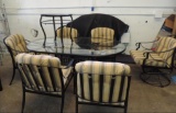Black metal oval patio table with 6 chairs, side table and cushions.