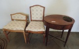 vintage oval table with copper planter insert and 2 upholstered chairs.