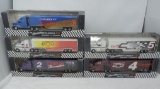 5 limited edition 1/64 scale racing transporter die cast trucks.