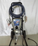 Graco Magnum XR7 paint sprayer with hose and spray gun.