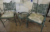 Cast metal patio chairs and glass top end table set.