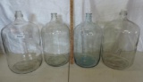 4 large glass jugs.