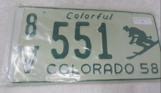 Pristine NOS condition 1958 colorful colorado skier license plate.