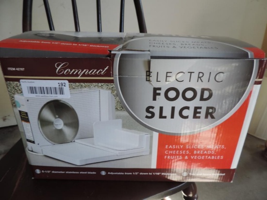 Compact electric food slicer with box.