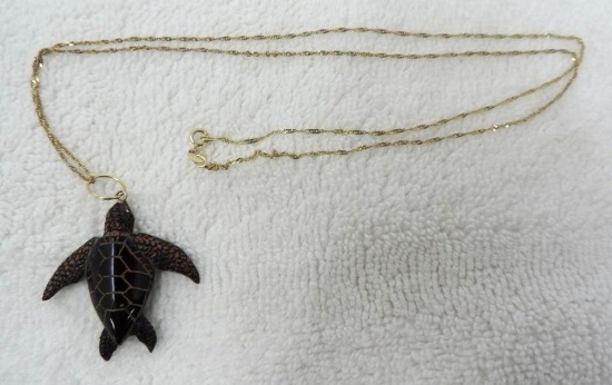 Small 14K gold chain with carved stone turtle.