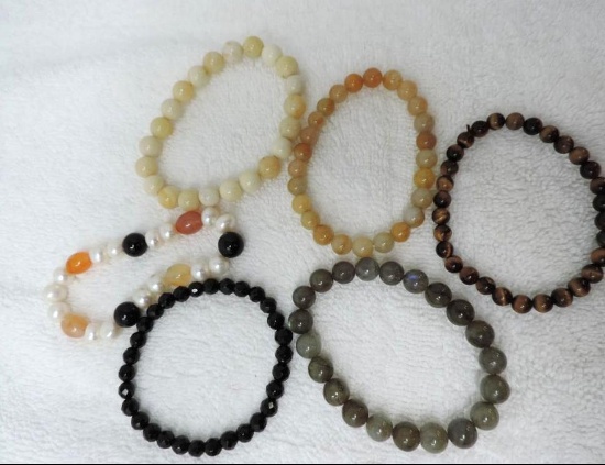 Six assorted stone bracelets.