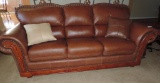 Brown Faux leather couch.