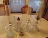 Four antique oil lamps.
