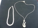2 bone colored necklaces.