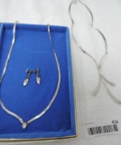2 silver necklaces and earrings.