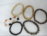 Six assorted stone bracelets.