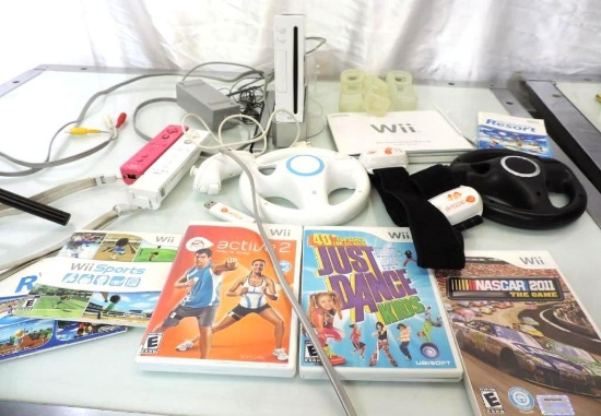 Nintendo Wii console with 2 controllers, 2 wheels, games and more.