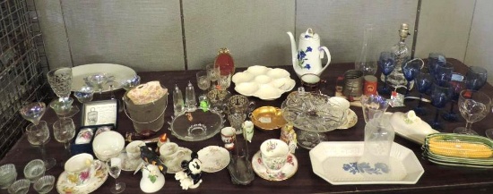 Table top full of antique glassware.