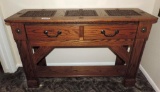 Ornate leather top oak sofa table with brass accents.