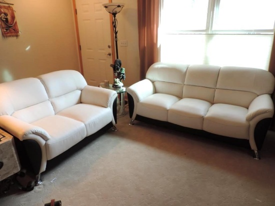 White and black modern faux leather couch and loveseat.