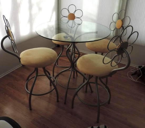 Bar height glass top table with 4 flower chairs.