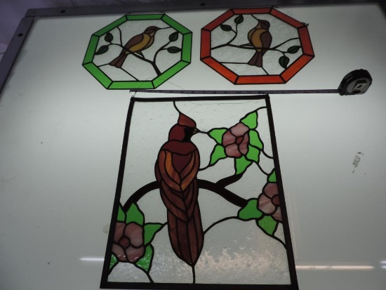 Three stained glass birds.