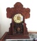 Ornate antique clock with key and pendulum.