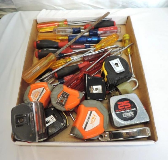 Screwdrivers and measuring tapes assortment.