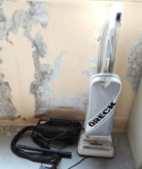 Oreck XL upright vacuum and black handheld vac with accessories.