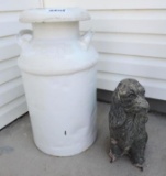 Milk can and concrete dog.
