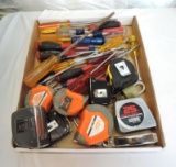 Screwdrivers and measuring tapes assortment.