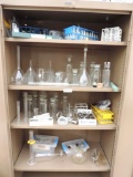 Large assortment of chemistry glassware.