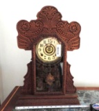 Ornate antique clock with key and pendulum.