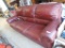 Maroon leatherette couch.