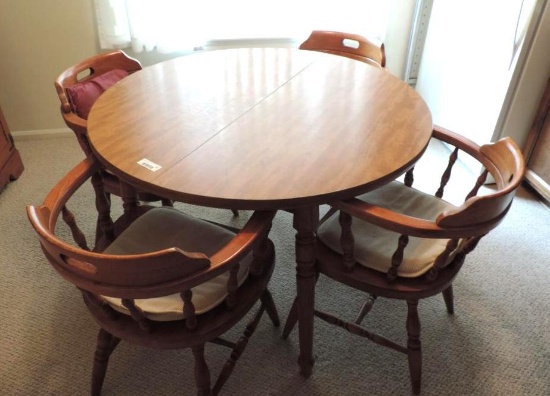Round table with 4 barrel back chairs.