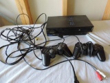 Sony PlayStation 2 with remotes.