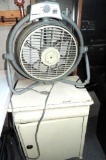 Vintage white commode and a Holmes air fan.