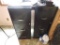 Two metal filing cabinets and black card table.