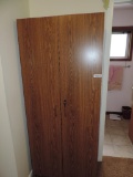 Particle board cabinet with key.