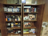 Two cabinets full of VHS tapes and books.