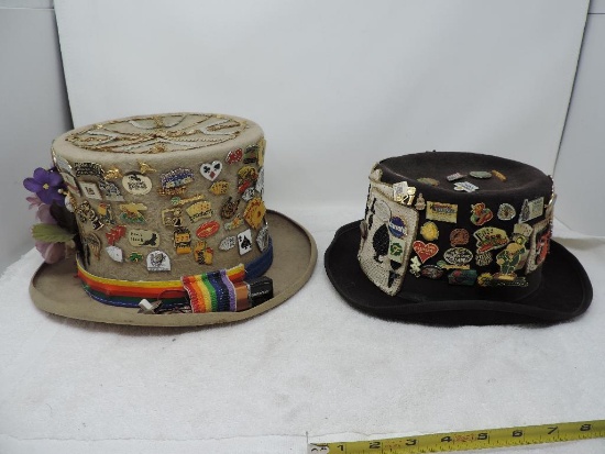 Two festive hats loaded with casino pins.